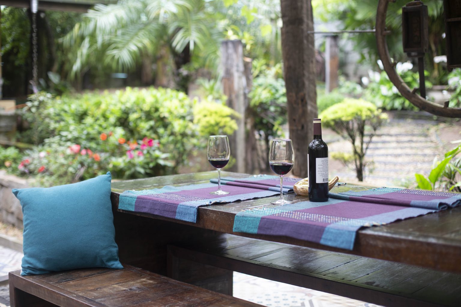 Moderne tuinmeubel trends 2021: grijze lounge set met houtlook parasol en vuurtafel op terras